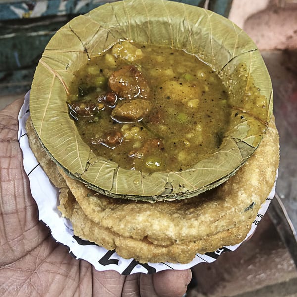 Fluffy kachoris served with spicy potato curry, a popular breakfast item at Kachori Gali.