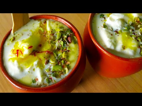 A rich, creamy yogurt drink topped with malai and a hint of saffron, famous for its thick texture and refreshing taste.
