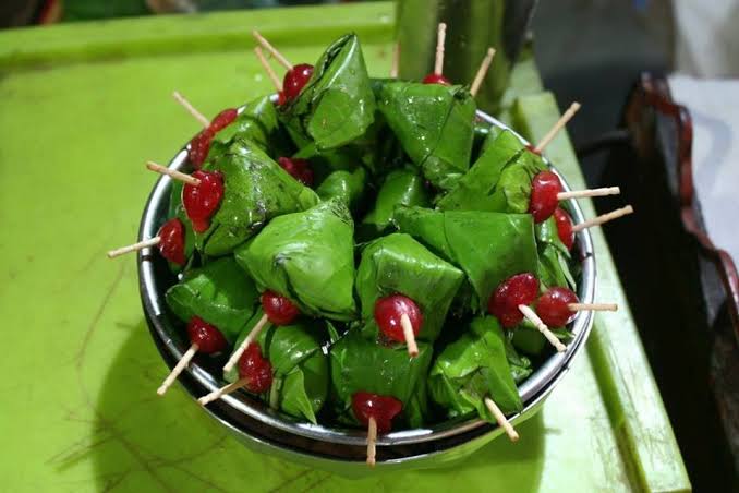 The famous betel leaf preparation with various sweet and savory fillings, a must-try experience.