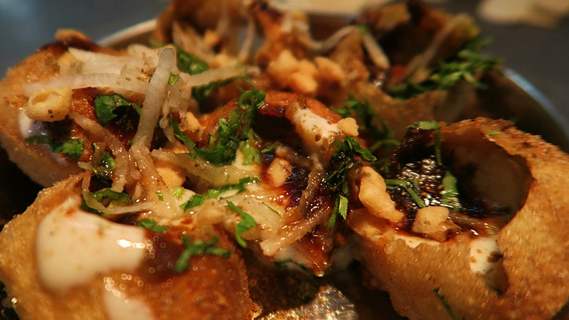 Crunchy, hollow puris filled with spicy, tangy water and flavorful fillings, offering an instant burst of taste with every bite.